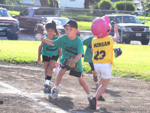 R-T Photo/Seth Herrold Cutler Epperson makes a play during the Green Ninjas and Bulldogs Midget League match-up on Thursday night at Ray Van Meter Park. Also pictured are Morgan Marrs (23), trying to avoid a tag from Epperson, and McKayla Mejia. The Midget League returns to Ray Van Meter Park tonight as the Mighty Midgets and Cardinals face off at 6 o’clock and the Orange Crush and Blue Gills see action at 7 o’clock.