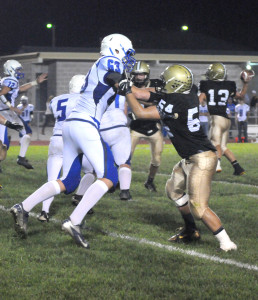 R-T Photo/Seth Herrold Jeramiah Chipps puts a block on a member of his former team, Stephan Elliott, during Trenton’s win on Friday night.