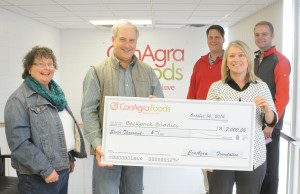 R-T Photo/Diane Lowrey ConAgra Foods has made a $7,000 donation to the Backpack Buddies Program, operated by the Grundy County Community Food Pantry. Pictured are, from left, front row, Food Pantry board members Ginny Wikoff and Dennis Browning, ConAgra plant manager Kim Hague; back row, human resources manager Chris Vansickle and associate human resources generalist Nolan Johnson.