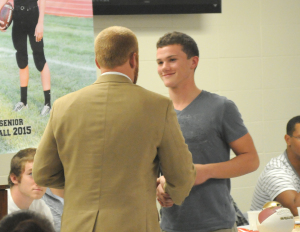 R-T Photo/Seth Herrold Trenton Head Coach Brandon Boswell presents Dalton Ellis with the Mr. Football Award at the Trenton Football banquet Friday night in the THS commons. Ellis amassed 1,232 career passing yards, ranking him fourth on the school’s all-time list.