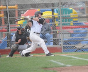 R-T Photo/Seth Herrold North Central’s Landon Figg drives a first-inning single during the Pirates’ game-one win on Friday at Burleigh Grimes Field. In the four-game series over the weekend, Figg hit .538 with two doubles, seven RBIs and six runs scored.