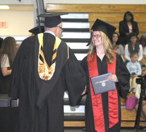 Molly Boyle of Trenton was one of 427 students receiving diplomas and certificates from North Central Missouri College. Miss Boyle is shown with NCMC Board of Trustees President Chris Hoffman.