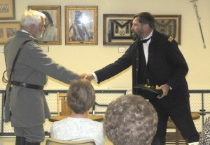 R-T Photo/Ronda Lickteig History came alive in Trenton Saturday afternoon as the Grundy County Museum presented “Lee and Grant at Appomattox,” a re-enactment of the days leading up to the surrender of the south during the Civil War. The event was held at the Trenton Masonic Lodge, with about 40 persons watching as Ulysses S. Grant, right, portrayed by Randal Durbin, and Robert E. Lee, portrayed by Lane Smith, led the audience through the negotiations and surrender. Above, the generals meet on April 9, 1865 at the McLean House in Appomatox Court House, VA to discuss the terms and conditions of a Confederate surrender.