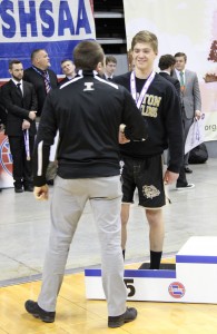 R-T Photo/Shani Kinney Trenton Head Coach Charlie Bacon congratulates Drew Rorebeck after the Trenton 145-pounder received his fifth-place medal at the Class 1 MSHSAA Wrestling Championships on Saturday in Columbia.