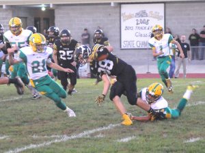 R-T Photo/Seth Herrold Colton Colston slips a tackle during Trenton’s conference win over Milan on Friday night. Colston gained five yards on the reception, his only catch of the night.