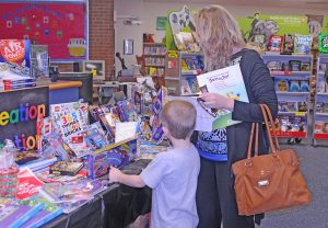 R-T Photo/Ronda Lickteig It was a “grand” night at the Rissler Elementary School PTO Book Fair, with grandparents invited to bring their youngsters to the event, being held this week in the school library. The fair will be held again from 3 to 5 o’clock tonight and from 3 to 7 p.m. on Friday. Friday’s events will also include the annual PTO chili supper, with serving to run from 5 to 7 p.m. in the school cafeteria. All proceeds from the activities will be used to fund PTO projects at the school. 